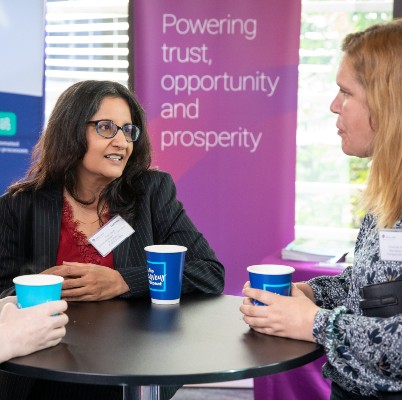three people conversing